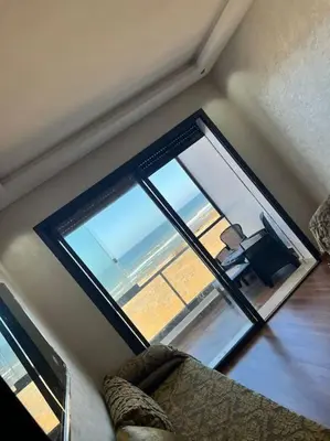 a living room with a large window with a couch at Appartement - EL Mansouria - Mohammadia - Bouznika in Mansouria