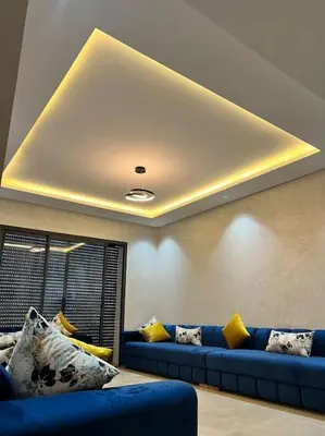 a living room with blue couches and yellow pillows at Appartement - EL Mansouria - Mohammadia - Bouznika in Mansouria