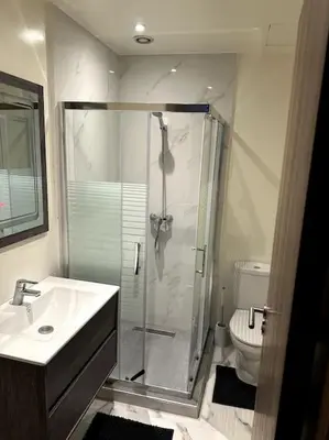 a bathroom with a shower and a sink and a toilet at Loft Moderne Cosy avec Terrasse vue unique centre de Casablanca in Casablanca