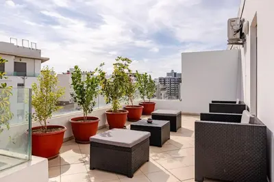 a balcony with potted plants on a building at Loft Moderne Cosy avec Terrasse vue unique centre de Casablanca in Casablanca