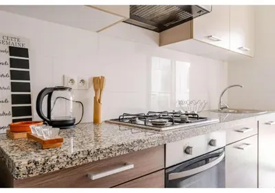 a kitchen with a stove and a counter top at Loft Moderne Cosy avec Terrasse vue unique centre de Casablanca in Casablanca