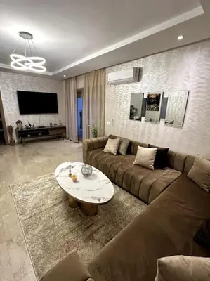 a living room with a couch and a table at Loft Moderne Cosy avec Terrasse vue unique centre de Casablanca in Casablanca