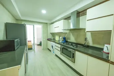 a large kitchen with stainless steel appliances in a room at Ocean Pearl - Exclusive 2BR Oceanfront Luxury & Views in Bouznika
