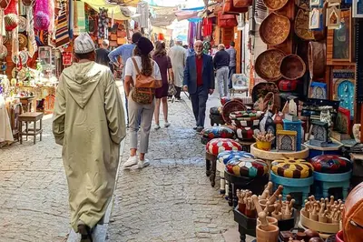 a group of people walking down a street in a market at Studio l'Escale D'Agdal in Rabat