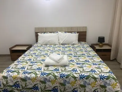 a bed with two white bags sitting on top of it at Studio l'Escale D'Agdal in Rabat