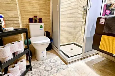 a bathroom with a toilet and a shower and rolls of toilet paper at Turner Vision in Casablanca