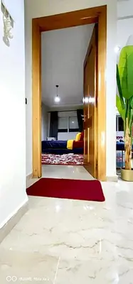 a hallway with a door and a red rug at Turner Vision in Casablanca