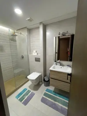 a bathroom with a toilet and a sink and a shower at les crêtes dar bouazza in Tamaris