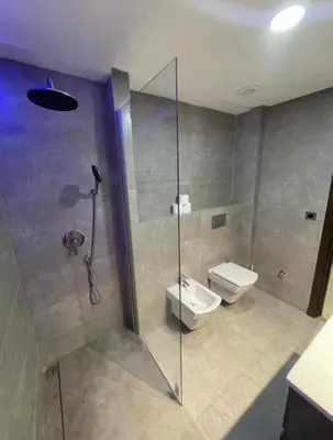 a bathroom with a shower and a toilet at les crêtes dar bouazza in Tamaris