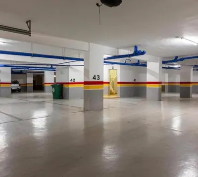 an empty parking garage with a large room with colorful walls at les crêtes dar bouazza in Tamaris