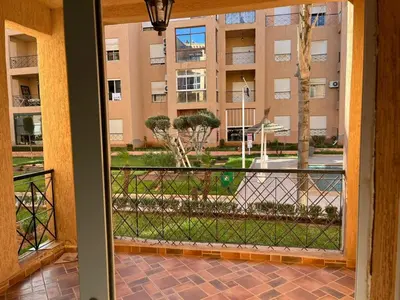 a view of a building from a balcony at Apartment in O Ben Slimane