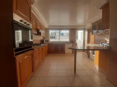 a kitchen with a table in the middle of it at Lux Appartement maarif in Casablanca