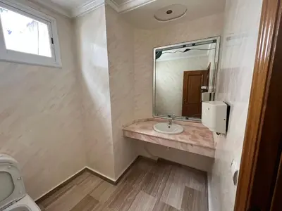 a bathroom with a sink and a mirror at Lux Appartement maarif in Casablanca