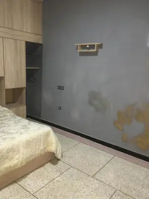 a bedroom with a wall with a painting of a bed at larc in Deroua