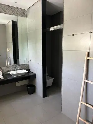 a bathroom with a sink and a mirror at Luxurious Golf Villa with Pool in Bouskoura