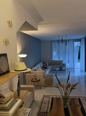 a living room with a couch and a table at Luxurious Golf Villa with Pool in Bouskoura