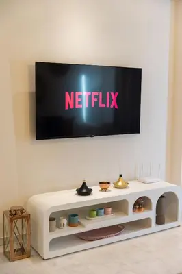 a flat screen tv on a white wall at Prestigia Luxe Suite by MERAT HOME in Rabat
