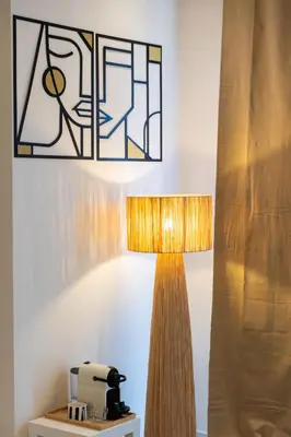 a lamp with a stained glass window next to a table at Prestigia Luxe Suite by MERAT HOME in Rabat
