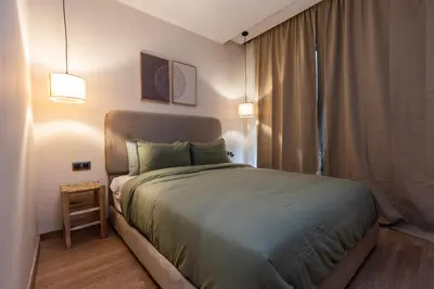 a bedroom with a large bed in a room at Prestigia Luxe Suite by MERAT HOME in Rabat