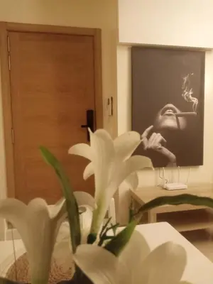 a white flower in front of a picture of a person at Downtown Stay 1Br near Tramway - Parking in Casablanca