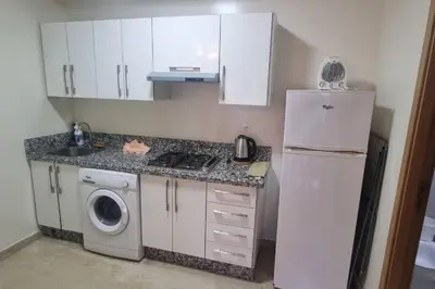 a kitchen with a white refrigerator and a washing machine at Downtown Stay 1Br near Tramway - Parking in Casablanca
