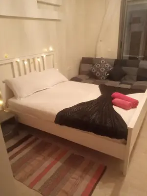 a bedroom with a bed and a couch at Downtown Stay 1Br near Tramway - Parking in Casablanca