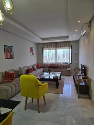 a living room with a couch and a yellow chair at Charmant appartement à 10min de L' Aéroport Med V in Nouaceur