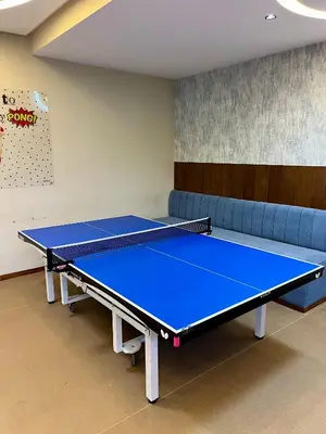 a ping pong table in a room with a couch at Sea view apartment in Casablanca