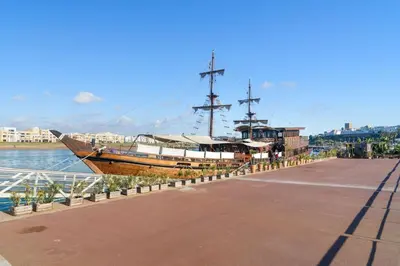 a large boat is docked next to the water at Appartement neuf luxe OLM à Rabat in Rabat