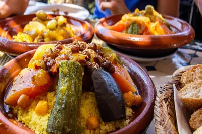 a table with bowls of food on a table at Appartement neuf luxe OLM à Rabat in Rabat