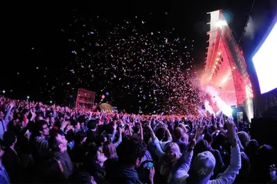 a crowd of people at a concert with their hands in the air at Appartement neuf luxe OLM à Rabat in Rabat