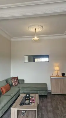 a living room with a green couch and a table at Welcome to km 0 of Casablanca in Casablanca