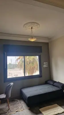 a bedroom with a bed and a window and a chair at Welcome to km 0 of Casablanca in Casablanca