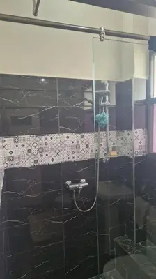 a bathroom with a shower with a glass door at Welcome to km 0 of Casablanca in Casablanca