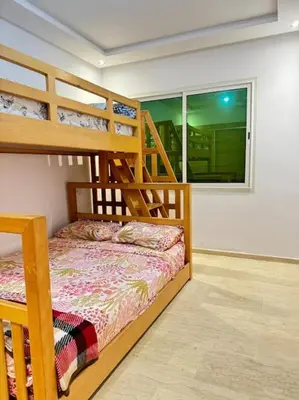 a bedroom with two bunk beds and a window at Nice appartement In Rabat-Temara in Temara