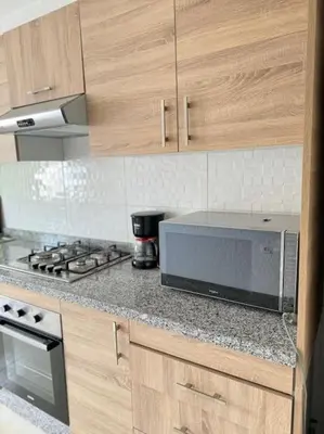 a kitchen with a counter top with a microwave at Nice appartement In Rabat-Temara in Temara