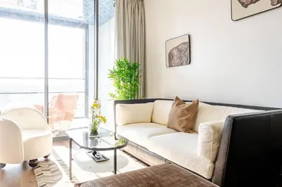 a living room with a couch and a table at Modern Ocean View Apartment in Casablanca