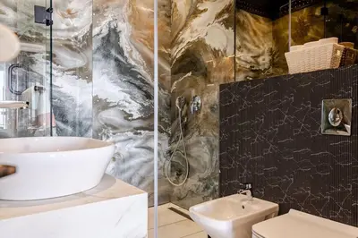 a bathroom with a sink and a shower and a toilet at Modern Ocean View Apartment in Casablanca