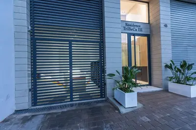 a building with a large metal garage door on it at So Chic & Lumineux Appartement Avec Terrasse Ensoleillée Au Coeur De Maarif Quartier Palmier Avec Parking Prés de Tramway Et Restaurants Luigi Casablanca in Casablanca