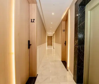 a hallway with a long hallway with numbers on the wall at So Chic & Lumineux Appartement Avec Terrasse Ensoleillée Au Coeur De Maarif Quartier Palmier Avec Parking Prés de Tramway Et Restaurants Luigi Casablanca in Casablanca