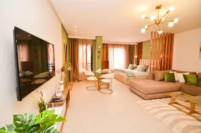 a living room with a couch and a tv at Studio 07 Maarif - High Speed Wi-Fi in Casablanca