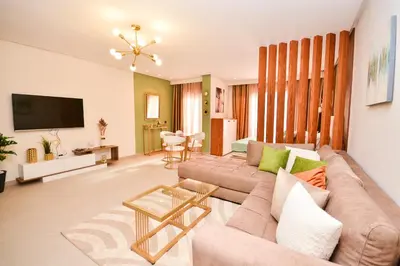a living room with a couch and a tv at Studio 07 Maarif - High Speed Wi-Fi in Casablanca