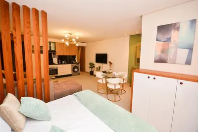 a bedroom with a bed and a living room at Studio 07 Maarif - High Speed Wi-Fi in Casablanca
