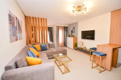 a living room with a couch and a table at Studio 08 Maarif - High Speed Wi-Fi in Casablanca