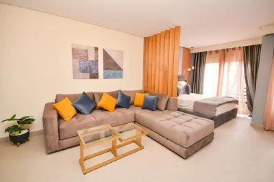 a living room with a couch and a table at Studio 08 Maarif - High Speed Wi-Fi in Casablanca