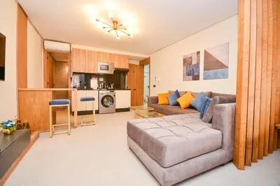 a living room with a couch and a table at Studio 08 Maarif - High Speed Wi-Fi in Casablanca