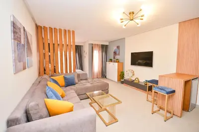 a living room with a couch and a table at Studio 08 Maarif - High Speed Wi-Fi in Casablanca
