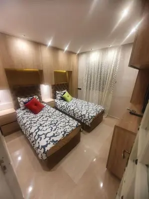 a bedroom with two beds and a window at Grand et magnifique appartement in Casablanca