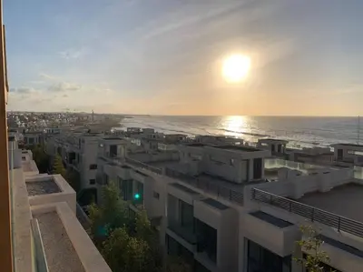 a view of the ocean from a building at The Atlantica Ocean view apartment in Dar Bouazza