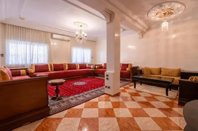 a large living room with couches and a checkerboard floor at Appartement Cosy et Confortable in Casablanca